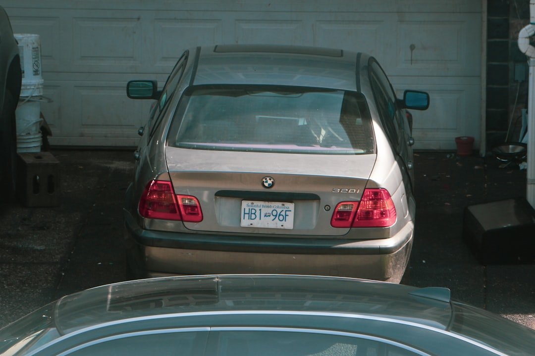 a silver car parked in front of a garage