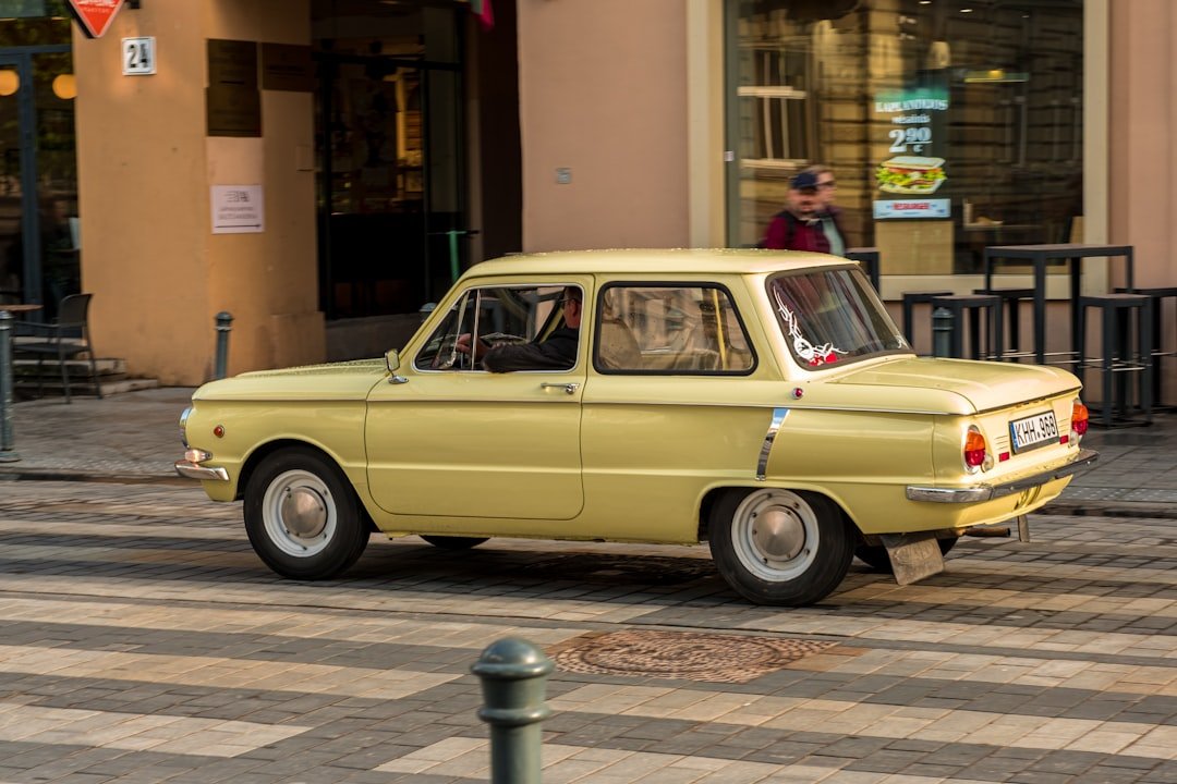 a small yellow car parked on a street
