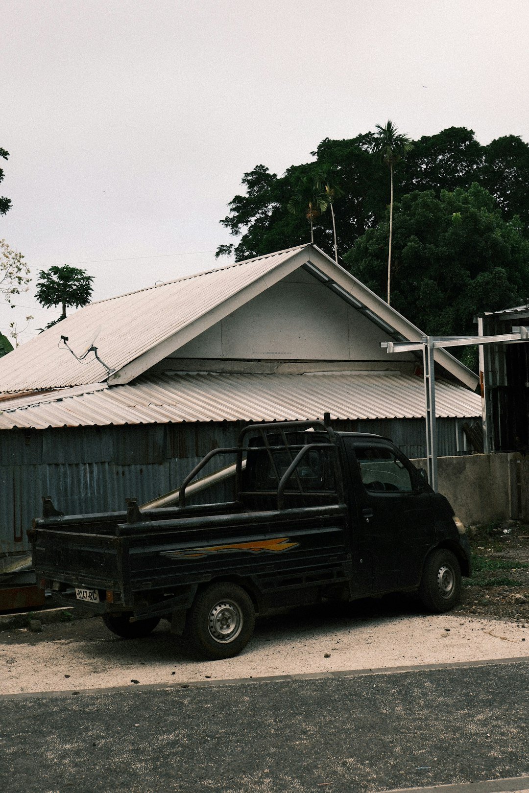 Black pickup truck parked near a house