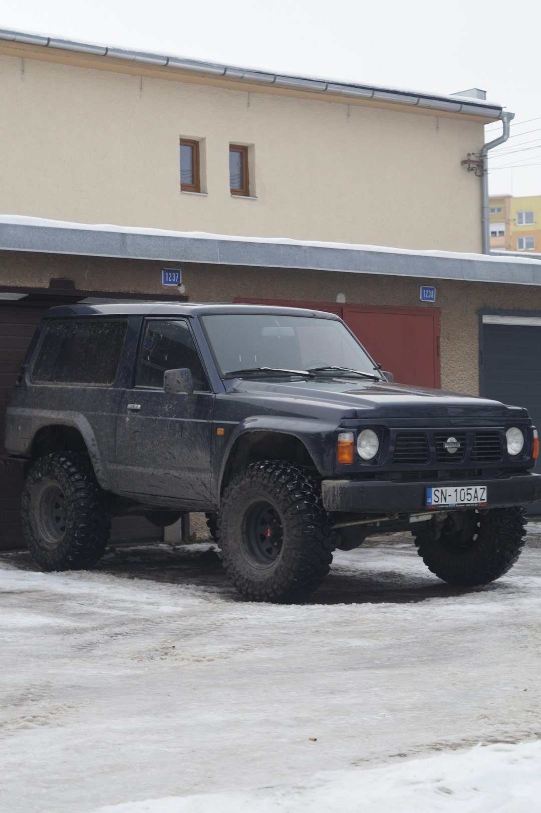 a black truck parked in front of a building