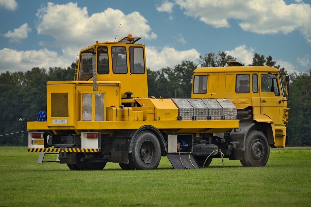 Yellow airport tow tractor with two cabins