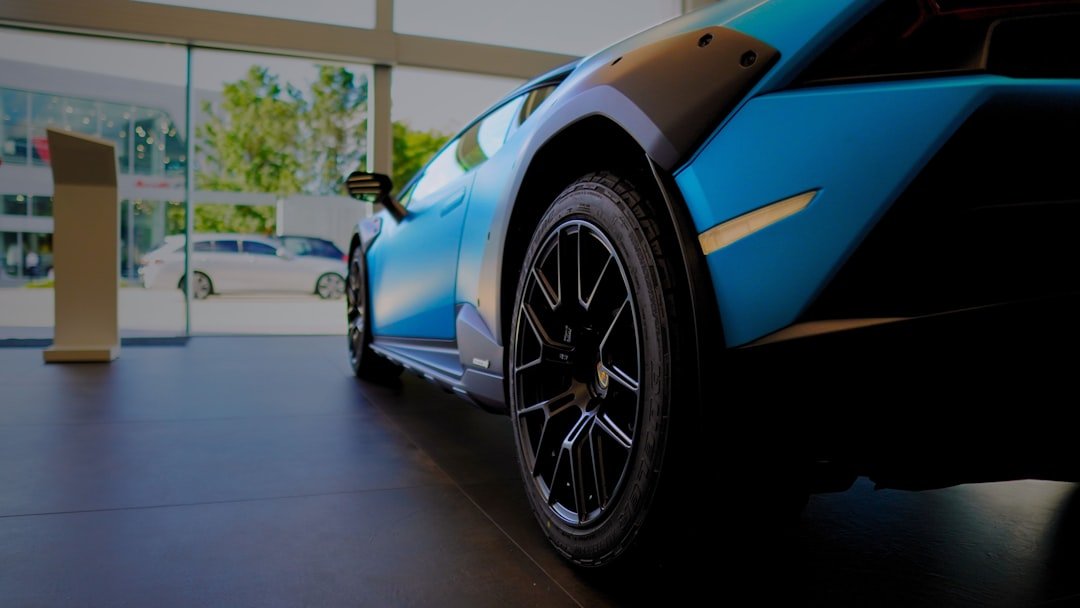 A blue and black sports car parked in a garage