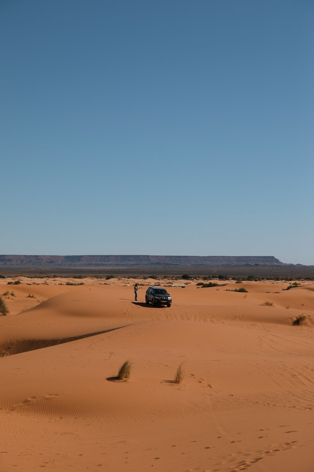 a car in the middle of the desert
