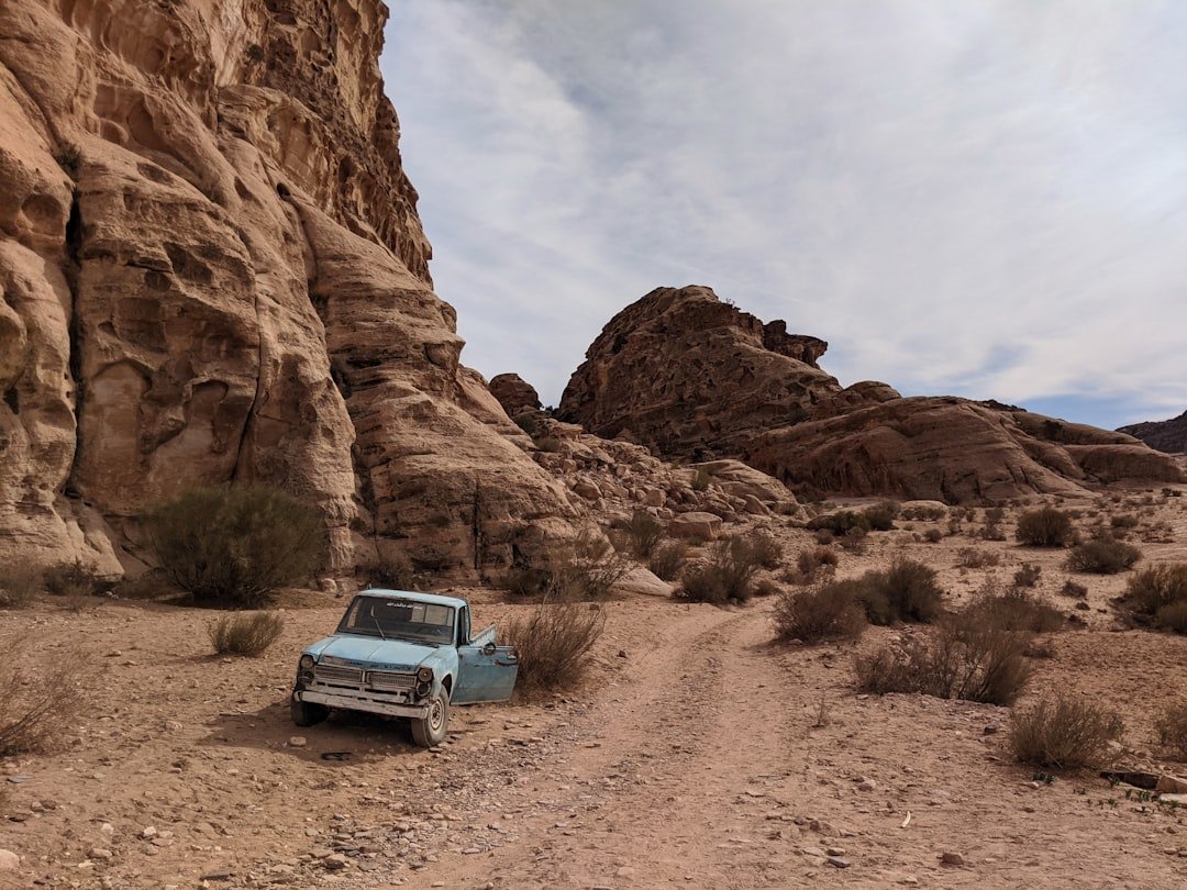 an old truck is parked in the desert