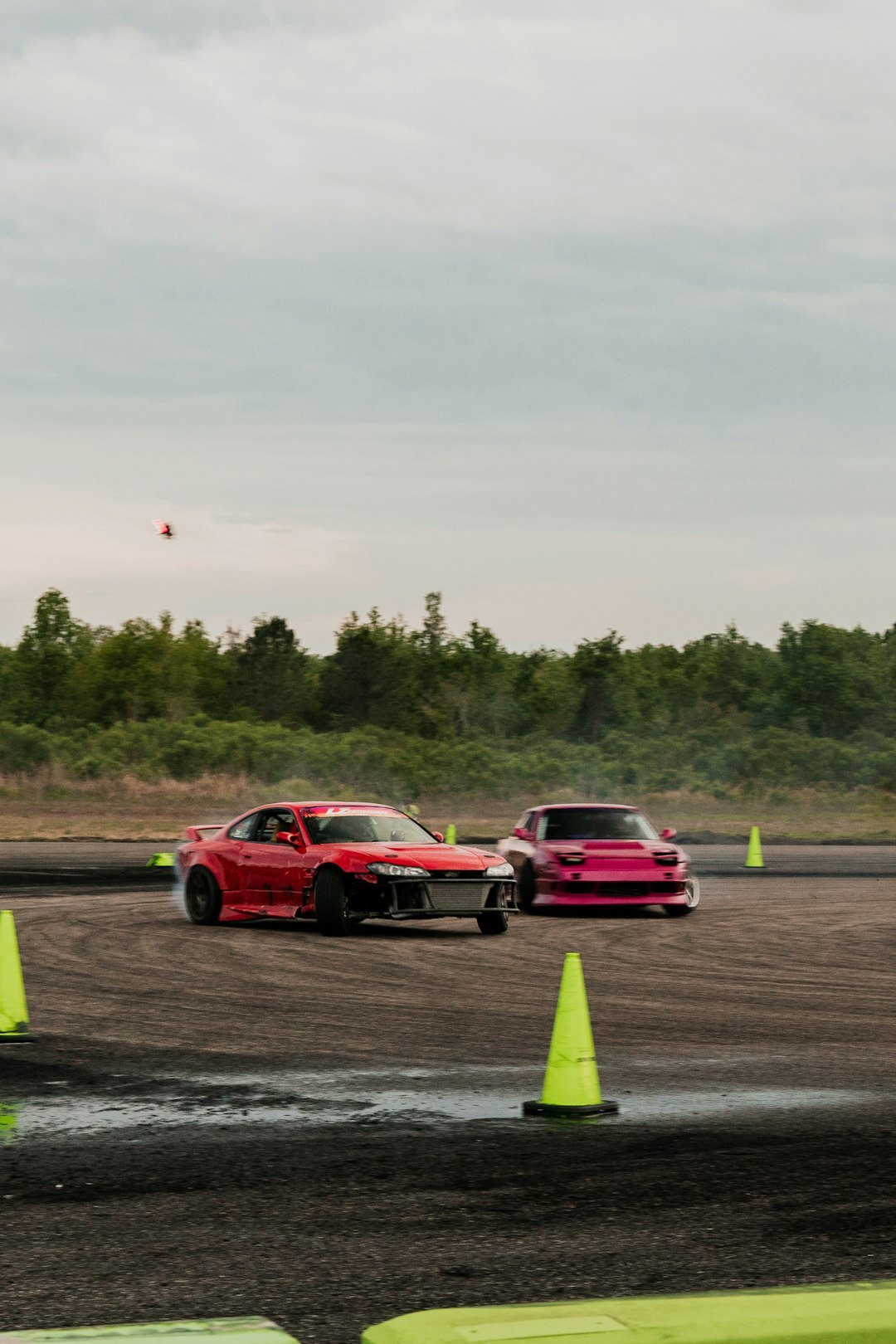 a couple of cars that are sitting in the dirt