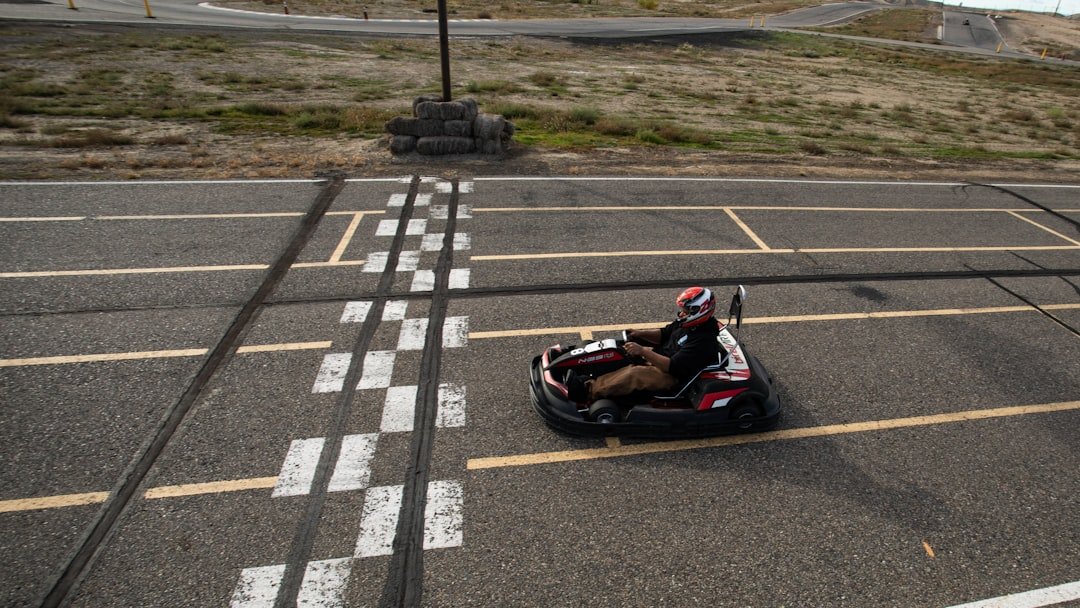 a person riding a go - cart in a parking lot