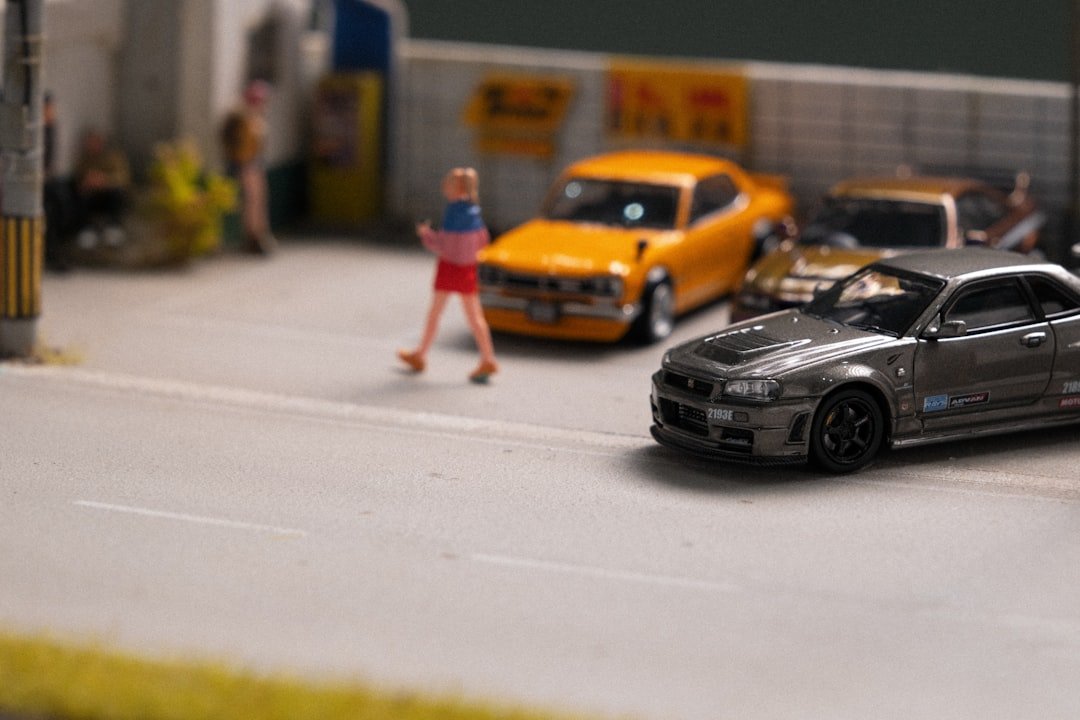 A model of a car show with a woman walking by