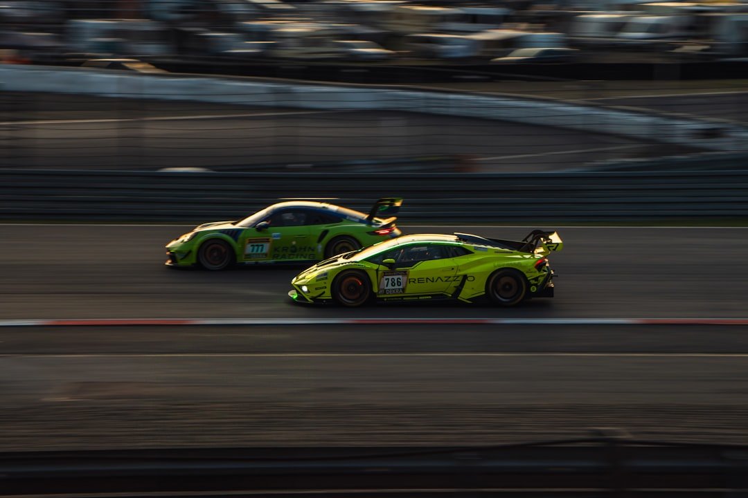 Two race cars speed down a track.