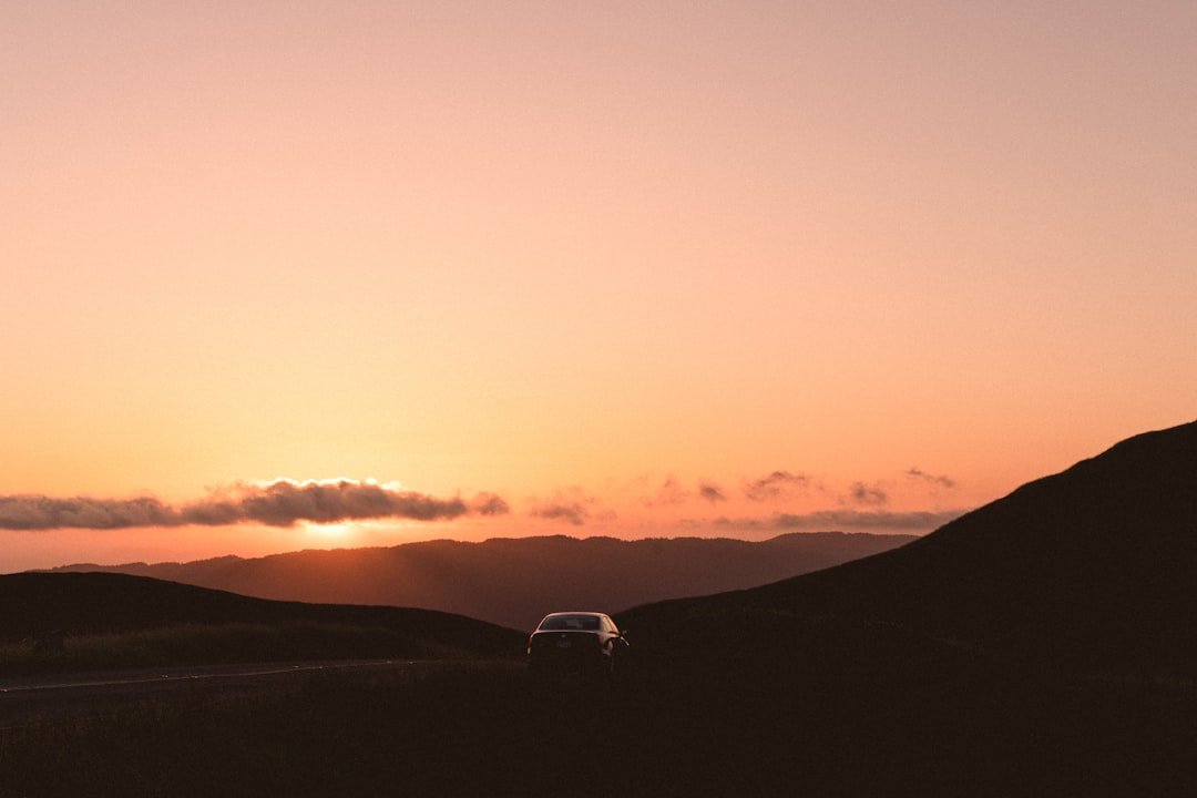 black sedan on road during golden hour