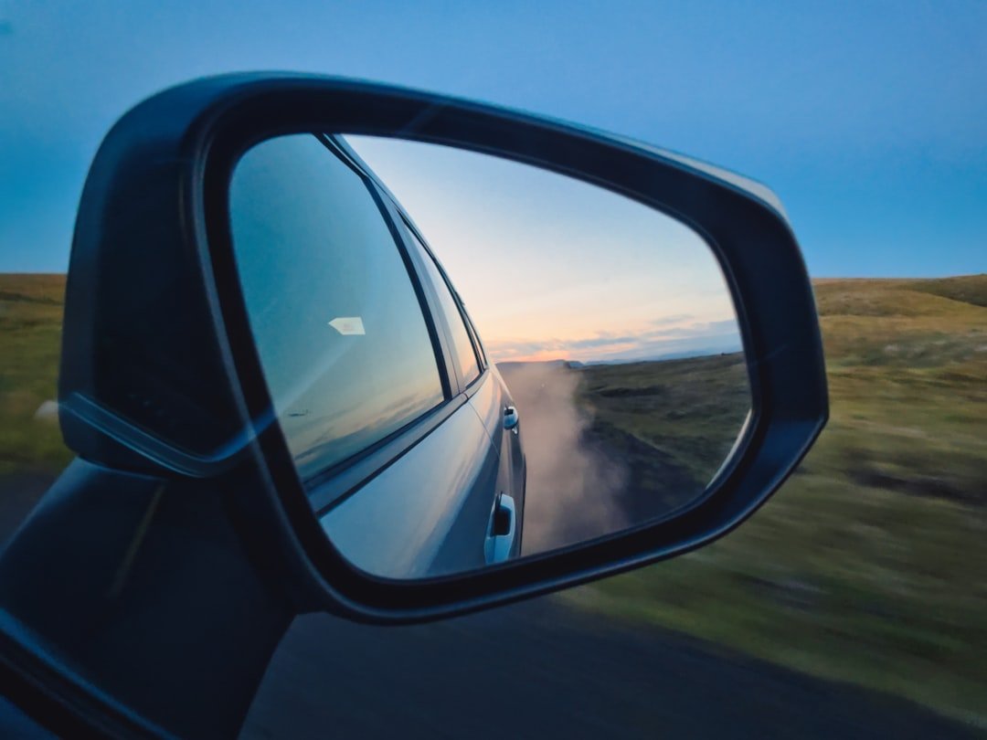 A rear view mirror on the side of a car