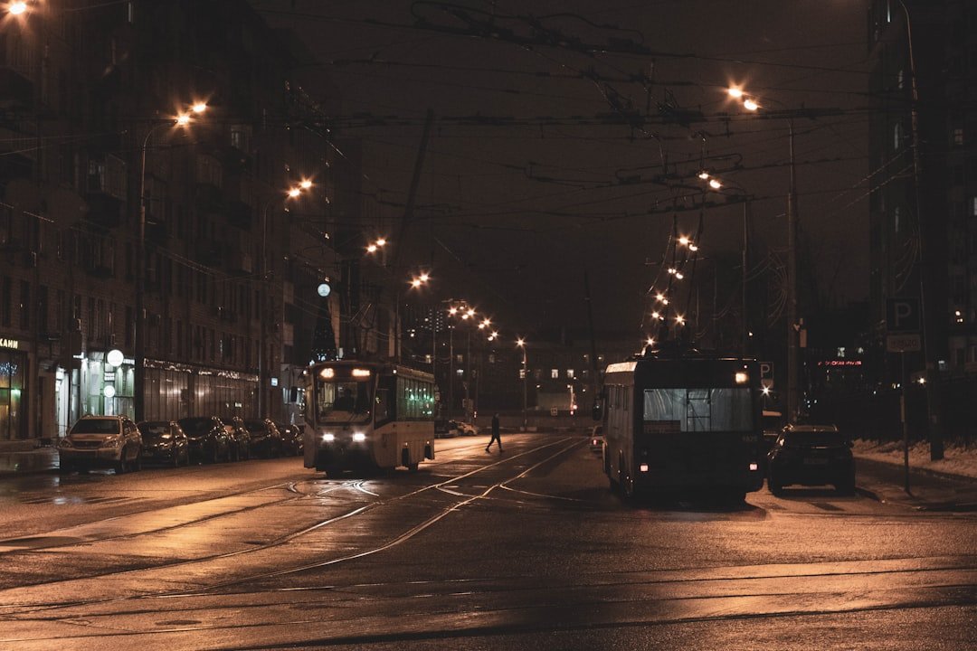 white and gray bus at road during night time