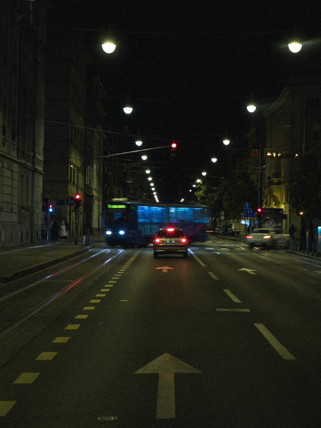 red and black bus on road during night time