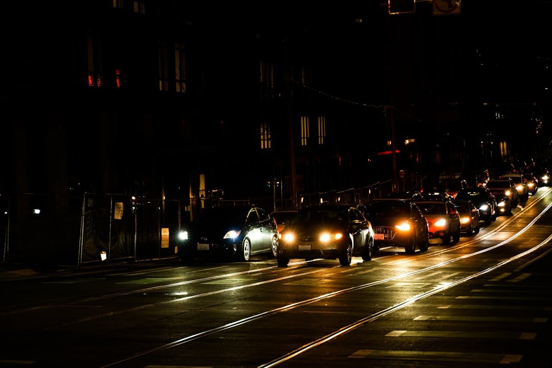 a street filled with lots of traffic at night
