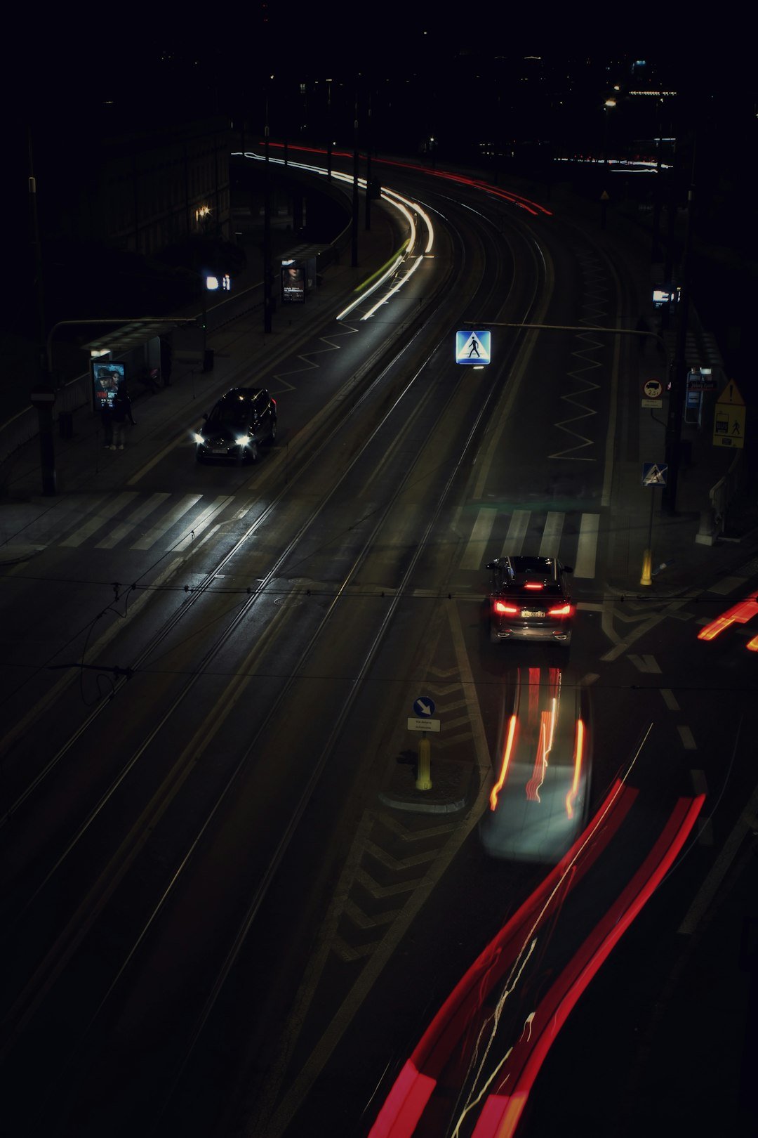 Nighttime cityscape with light trails from traffic.