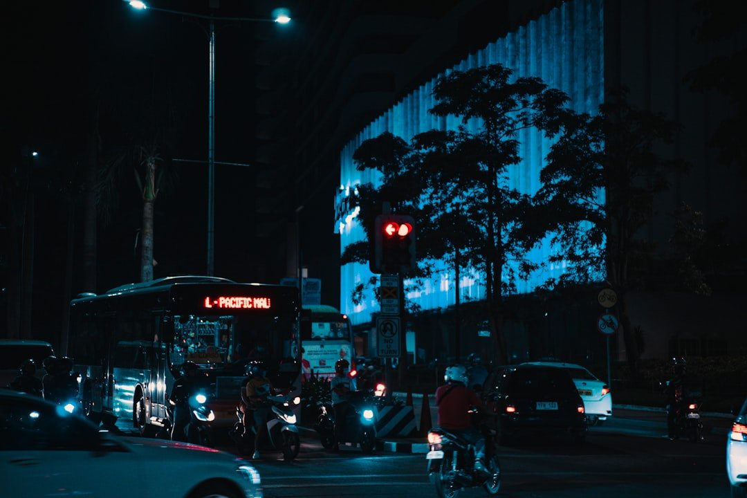 a city street filled with traffic at night