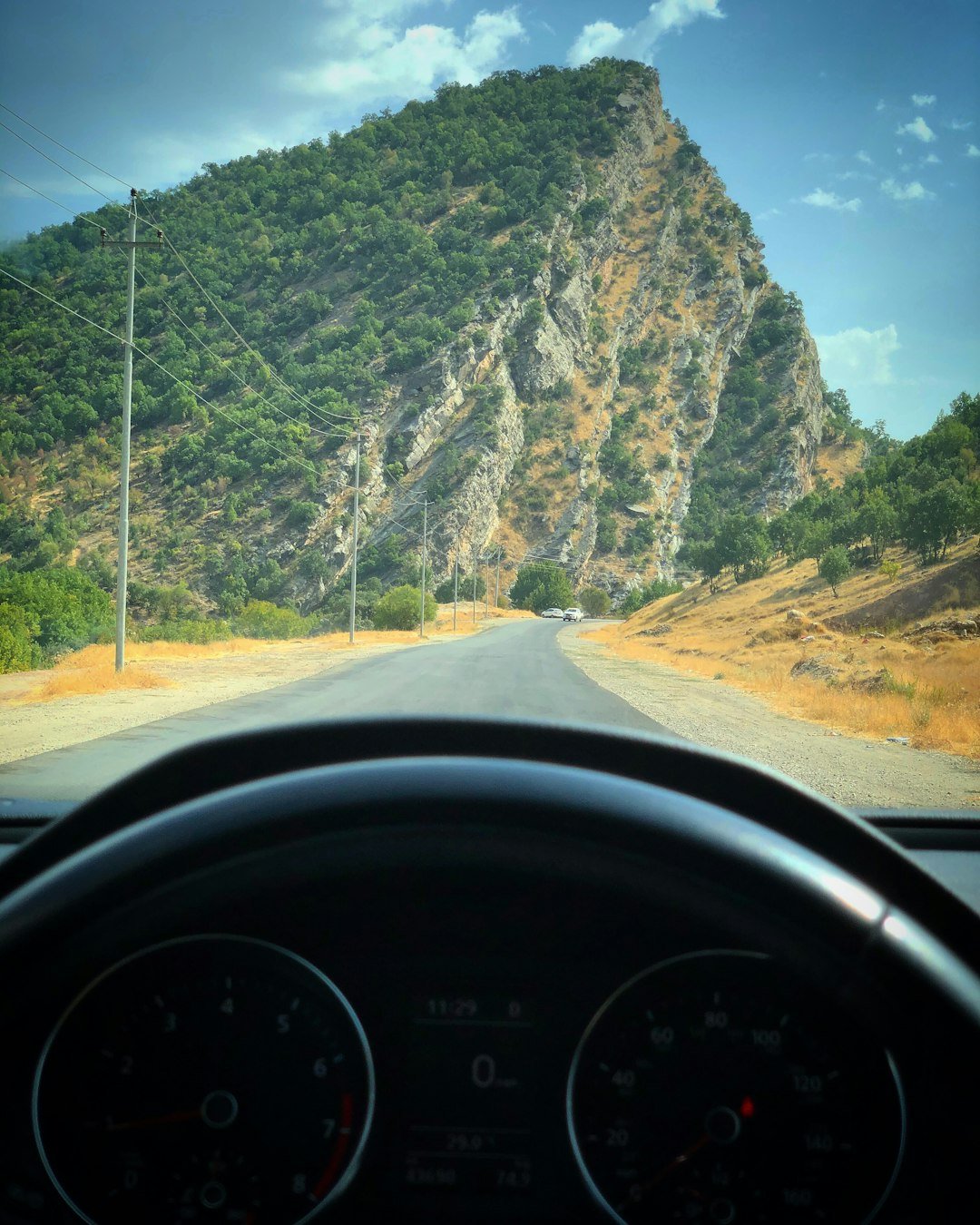concrete road near mountain during daytime