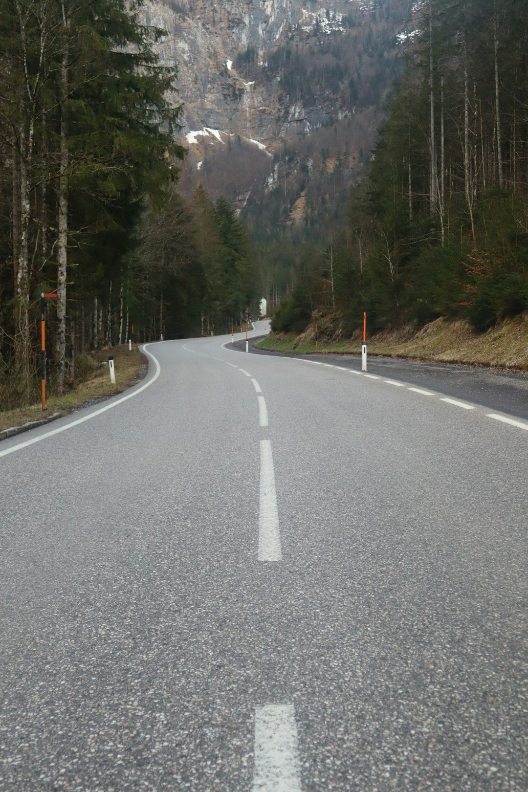 An empty road with a mountain in the background