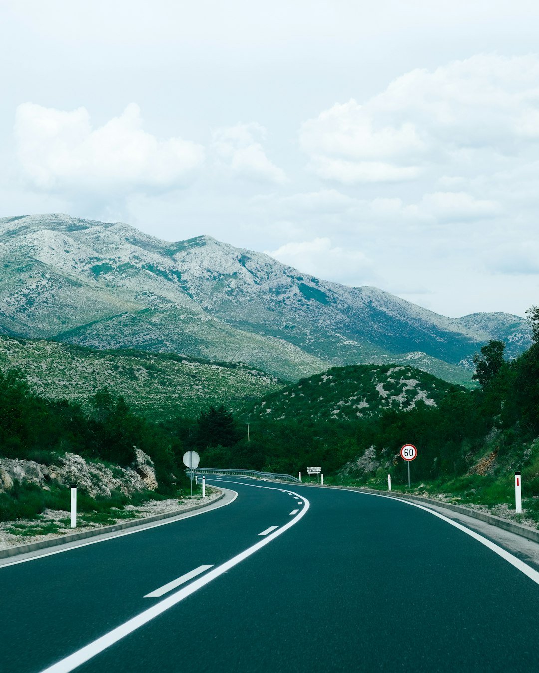 An empty road with mountains in the background