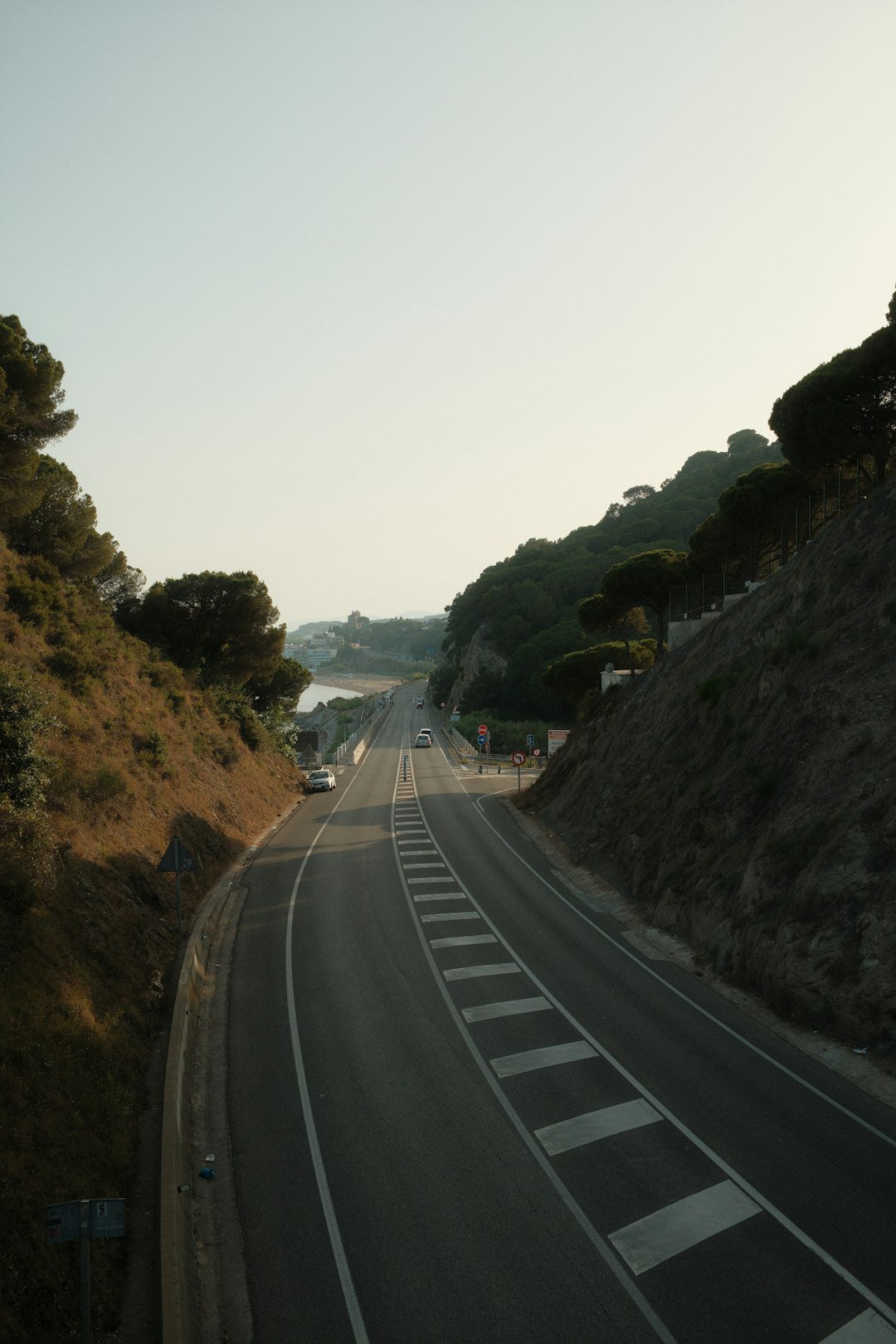 An empty road through mountains.