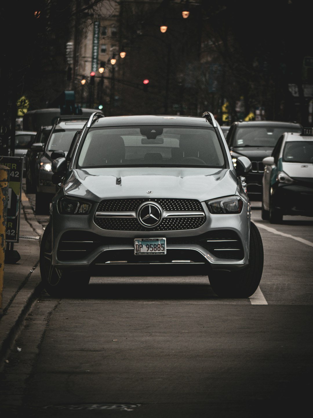 a mercedes car is parked on the side of the road