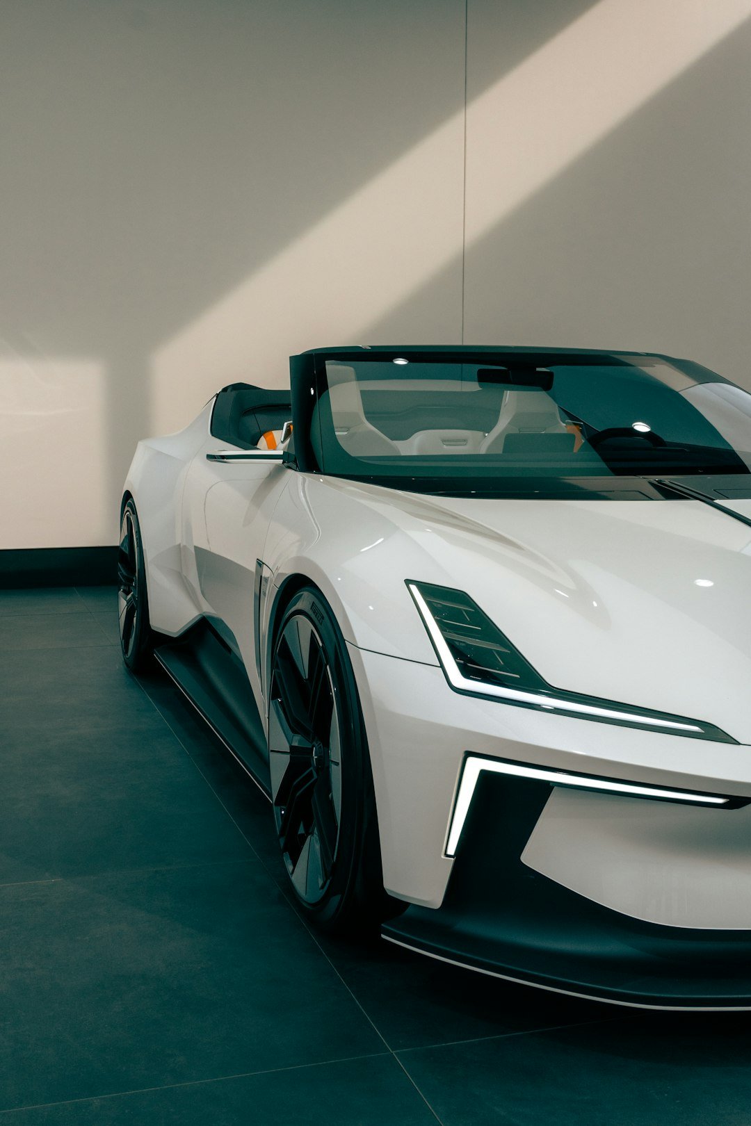 Sleek white convertible sports car with modern headlights