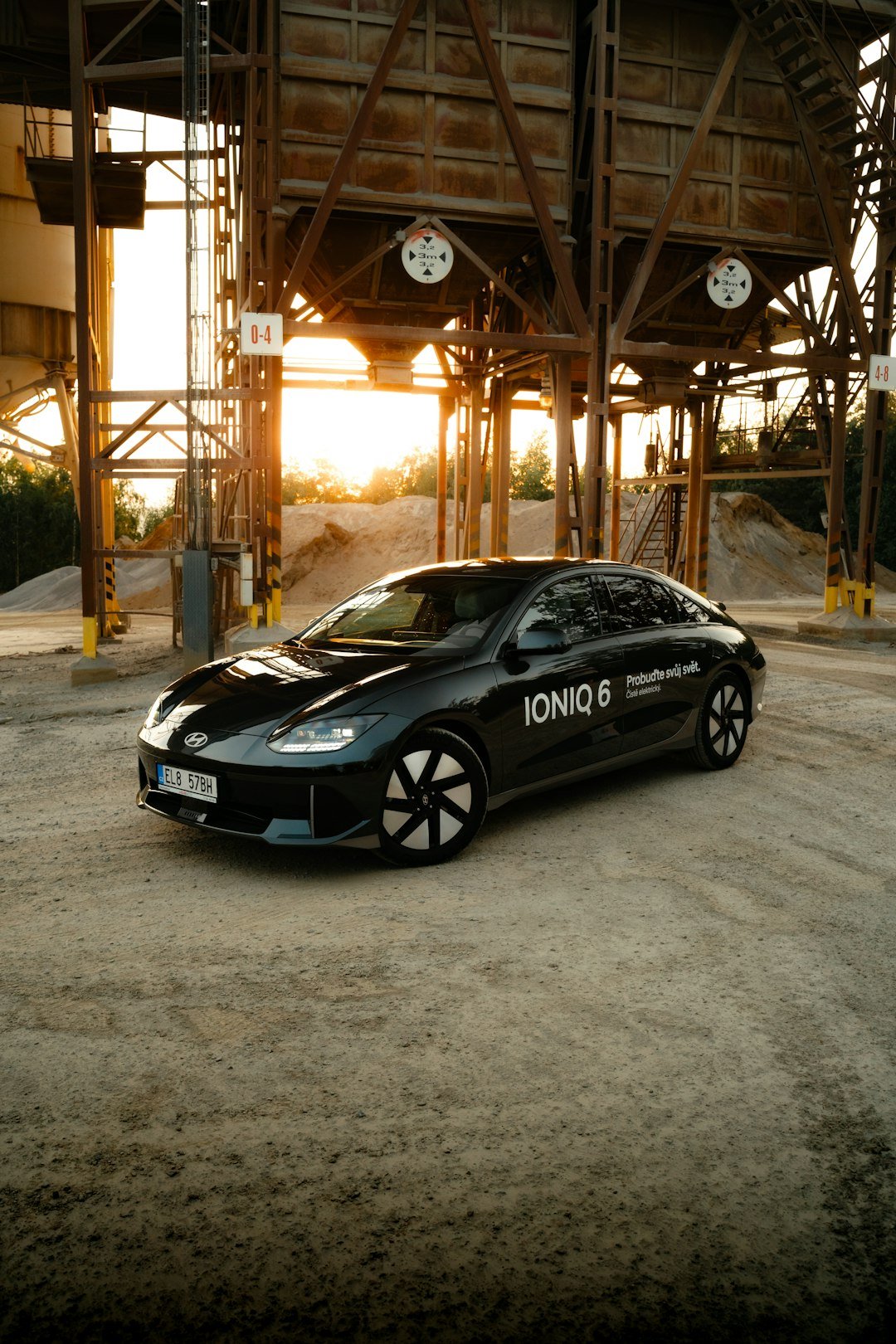 a black car is parked in a parking lot