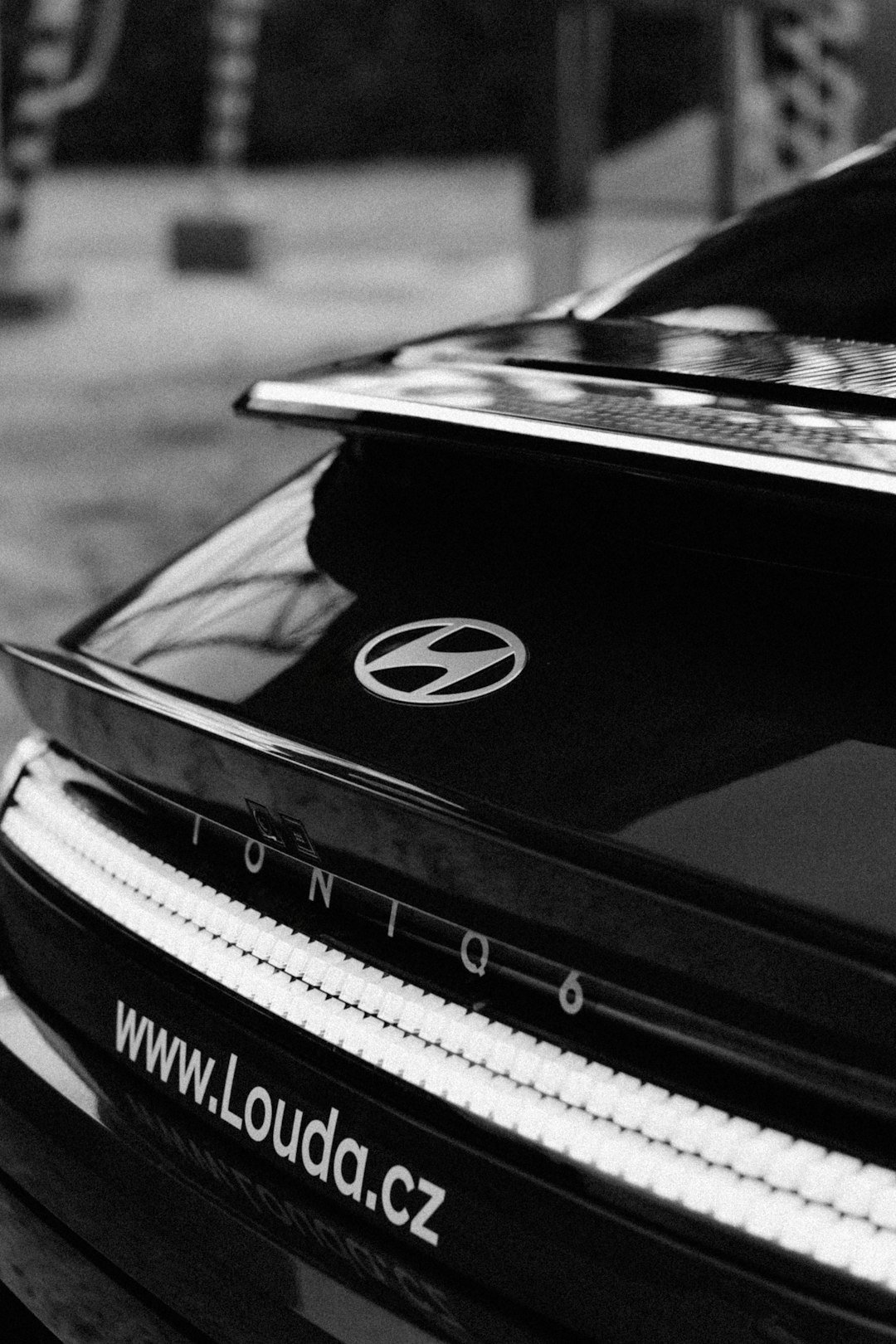 a black and white photo of the back of a car
